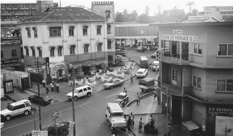 A busy street in Kumasi. Ghana&#x0027;s urban centers are dominated by European-style buildings, a reminder of its British colonizers.
