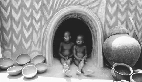 Children taking shelter from the midday heat. Located just north of the equator, Ghana has a warm, humid climate.